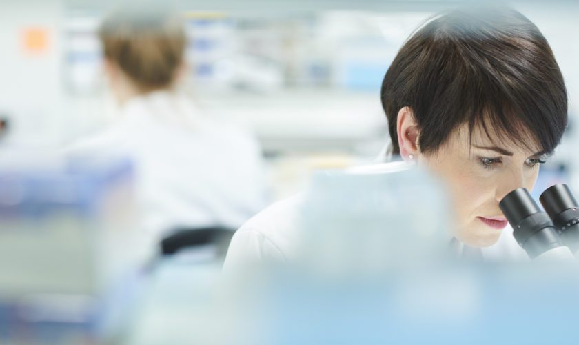 female scientist in a busy research lab
